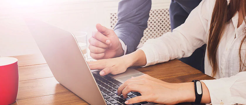 Colleagues working together at a laptop